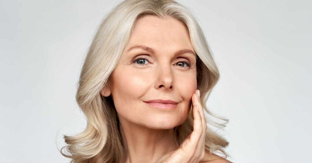 Woman with beautiful skin touching her face (model)