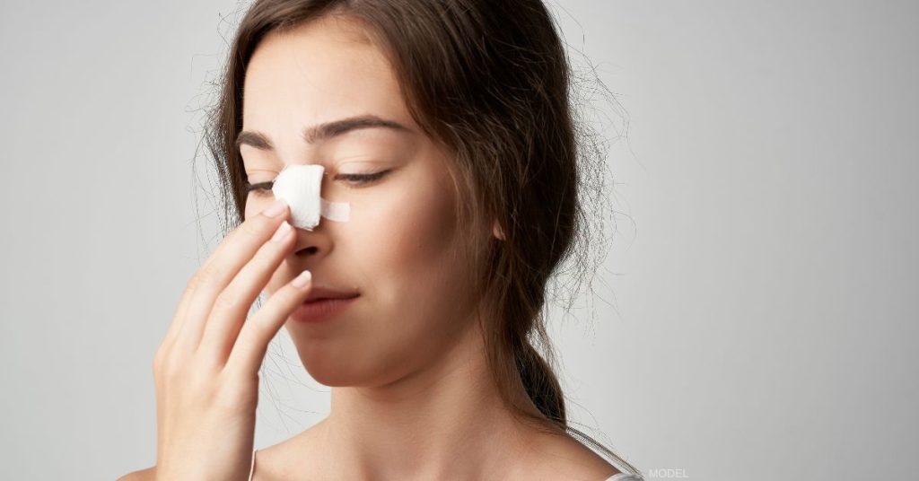 Woman with bandage on her nose (model)