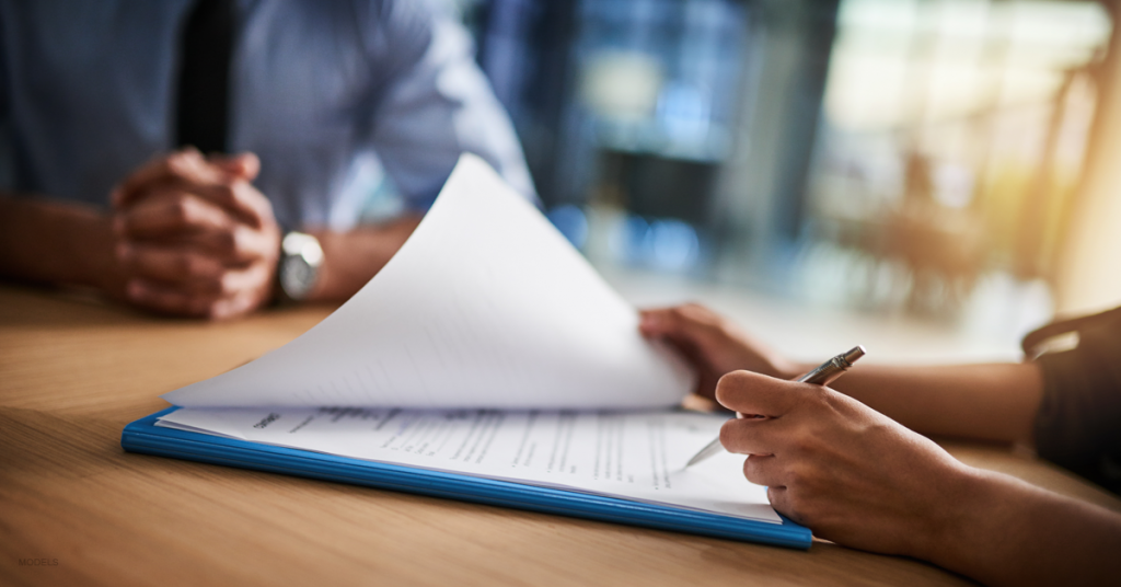 A patient reviews her list of questions during her plastic surgery consultation.