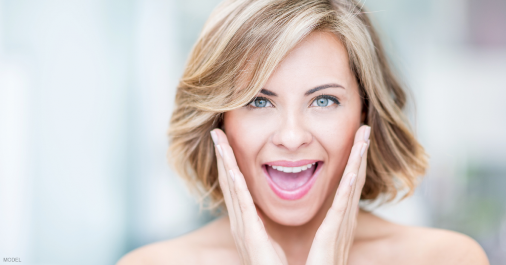 Woman is excited about the results of her cheek filler.