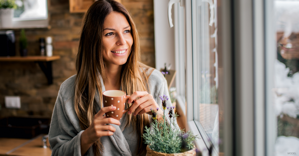 Woman looks rejuvenated and drinks her coffee.