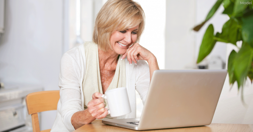 Woman researching about Facelifts on laptop