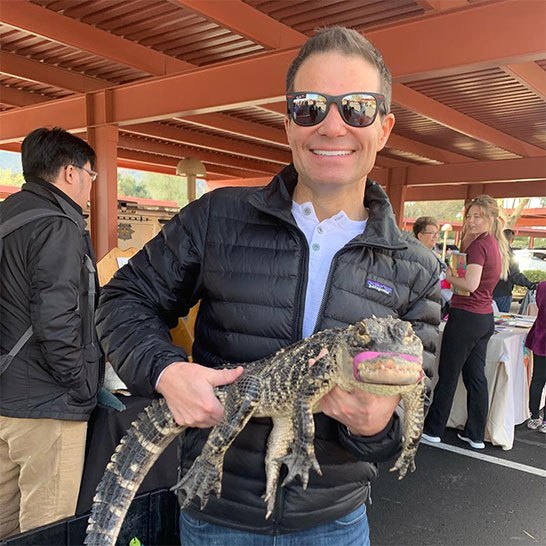 Plastic Surgeon Todd Hobgood holding alligator