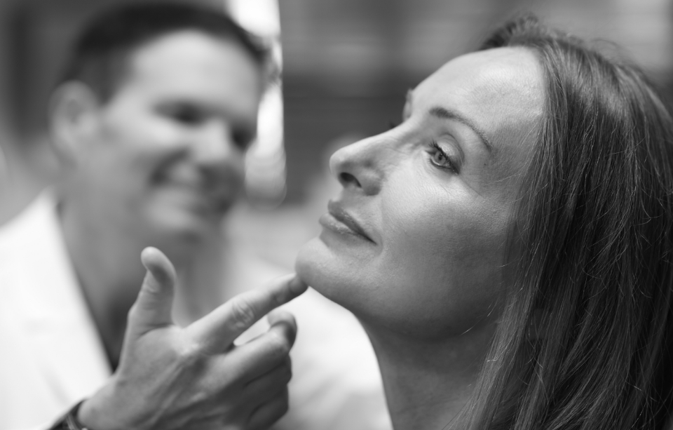 Dr. Hobgood looking at a woman's face