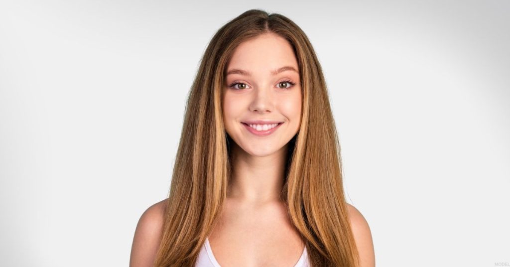 Smiling teenage girl after rhinoplasty (model)